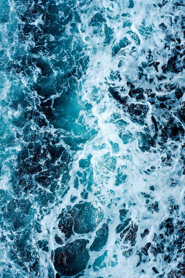 Blue Water With White Foam On The Surface Wallpaper