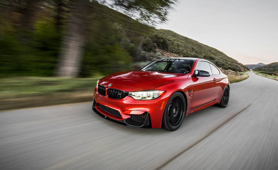 Bmw M4 Zooming On The Road Wallpaper