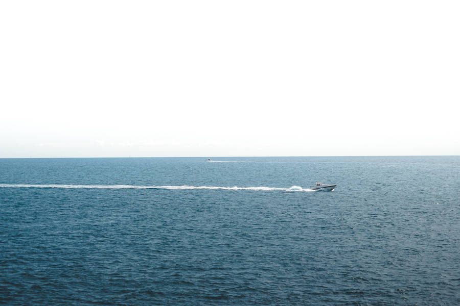 Boat At A Calming Sea Wallpaper