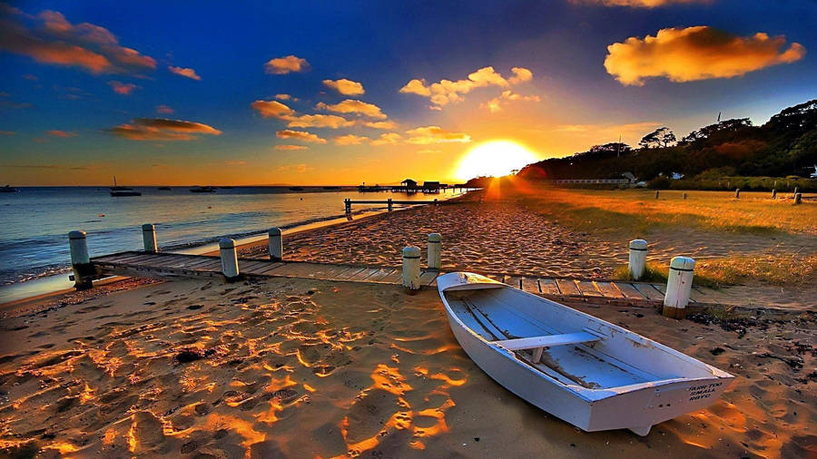 Boat Near Boardwalk On Beach Sunset Wallpaper