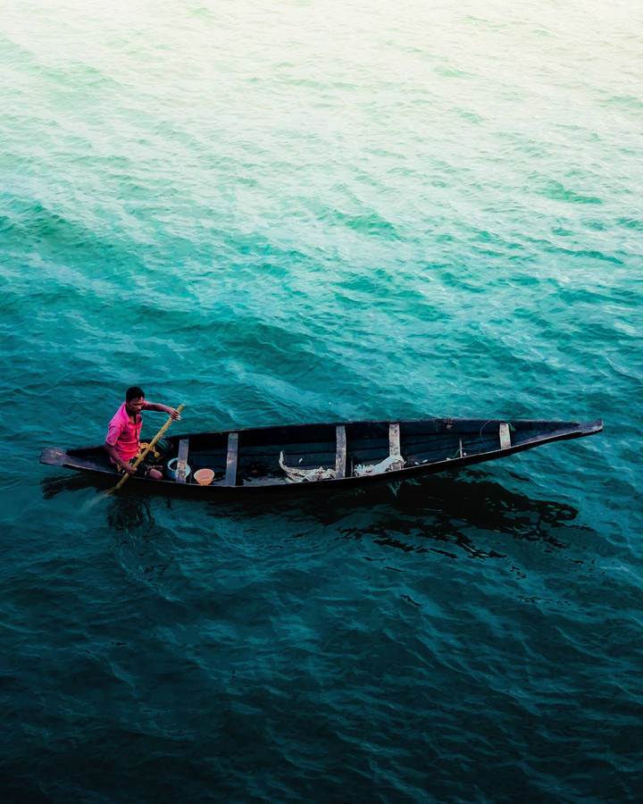 Boat On Beautiful Blue Water Wallpaper