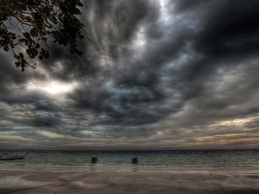 Boats Adrift Under Ominous Sky Wallpaper