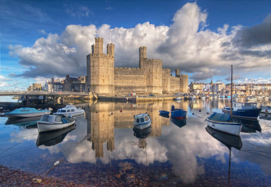 Boats Docked In The Water Near A Castle Wallpaper