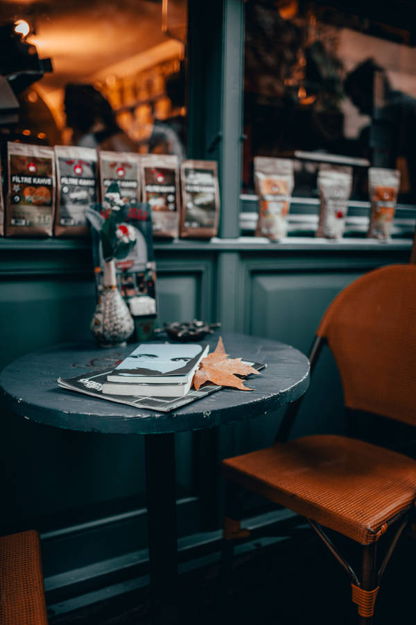 Book On A Coffee Shop Table Wallpaper