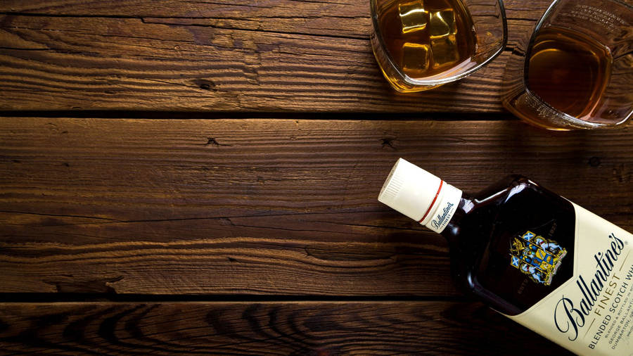 Bottle And Glasses Of Alcohol On Wooden Table Wallpaper