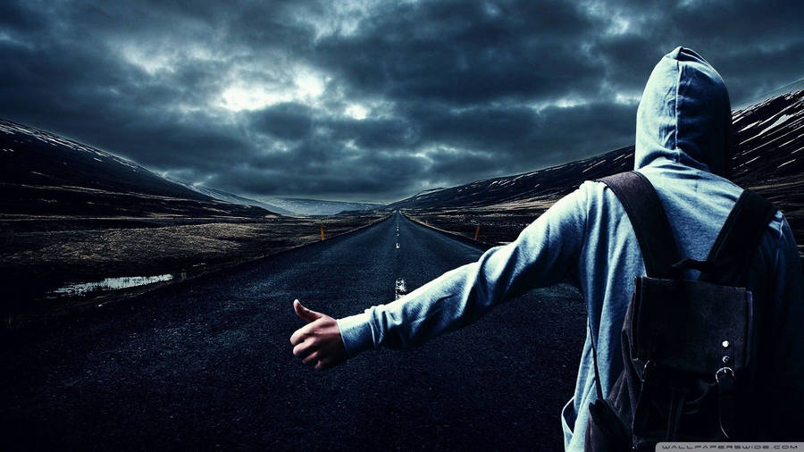 Boy In Hoodie Hitchhiking Wallpaper