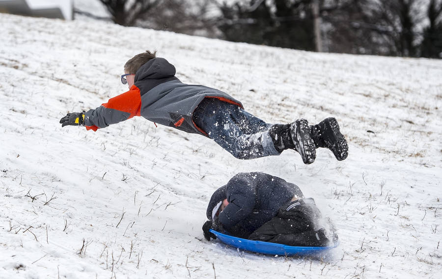 Boy Jump Over Sledding Wallpaper