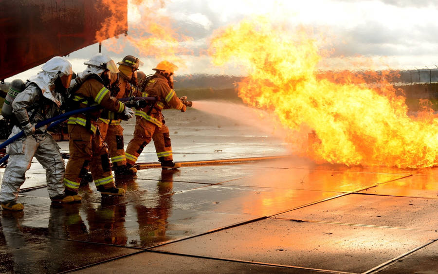 Bravery In Action: Firefighters Combatting Blaze Wallpaper