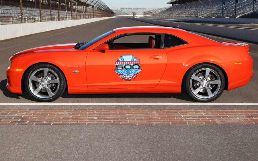 Breathtaking View Of A Red Camaro Sports Car At The Indianapolis 500 Wallpaper