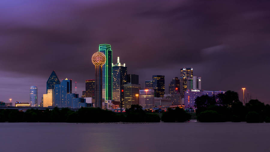 Breathtaking View Of Dallas Skyline Under Dark Clouds Wallpaper