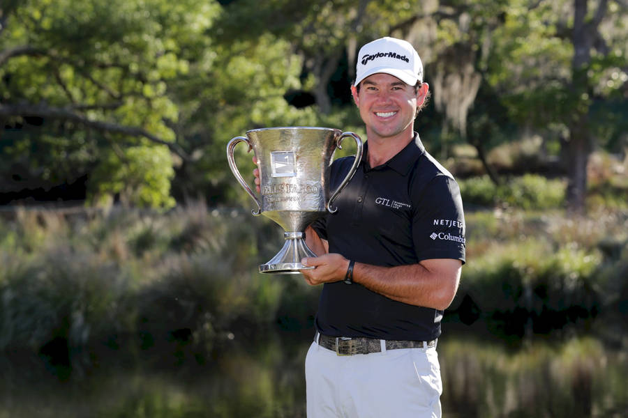 Brian Harman Holding A Prestigious Golf Trophy Triumphantly. Wallpaper