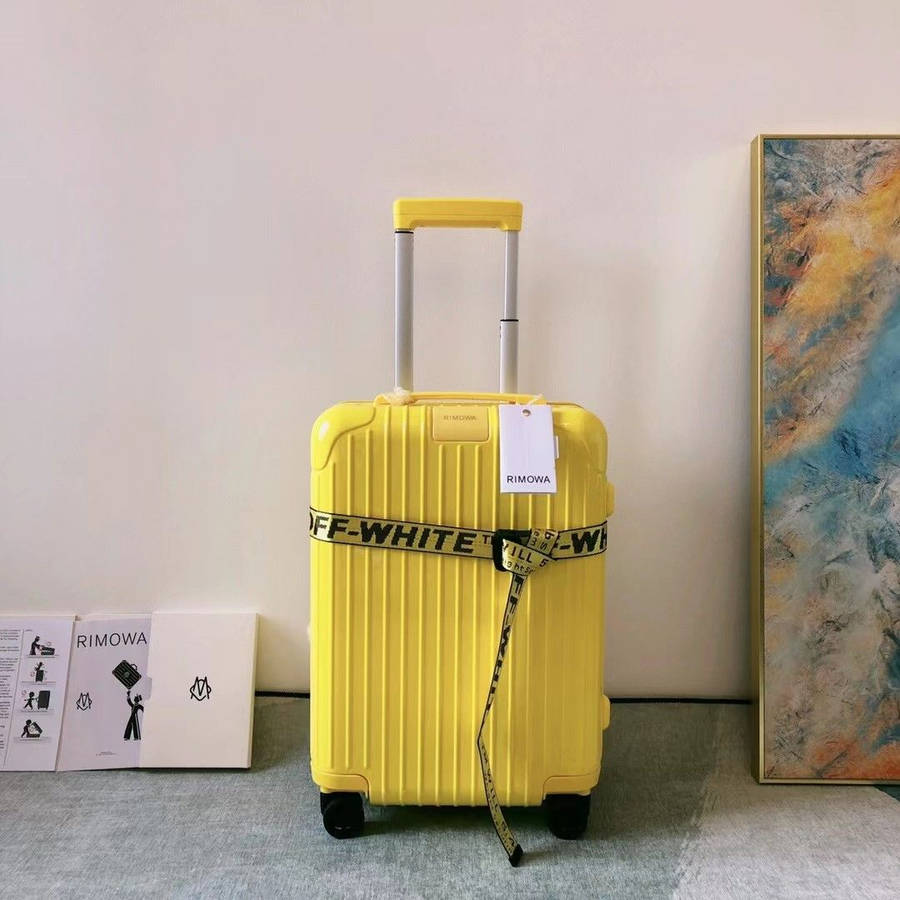 Bright Yellow Rimowa Suitcase Wallpaper