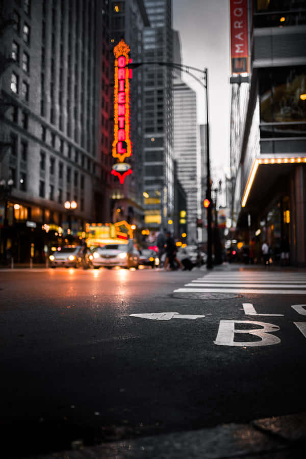 Brightly Lit New York Street At Night Wallpaper