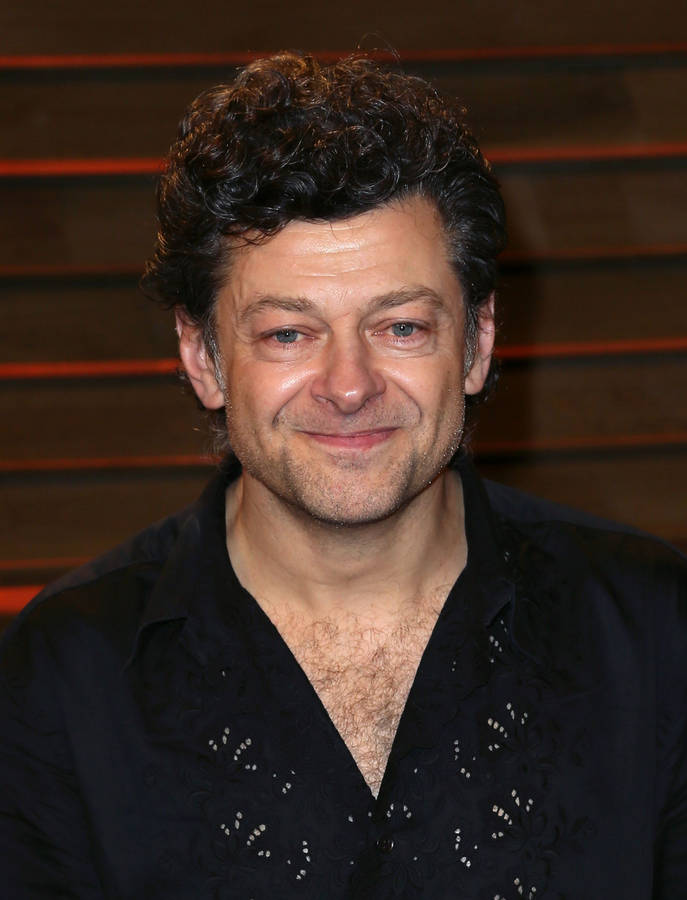 British Actor Andy Serkis Delivering An Invigorating Speech On Stage Wallpaper