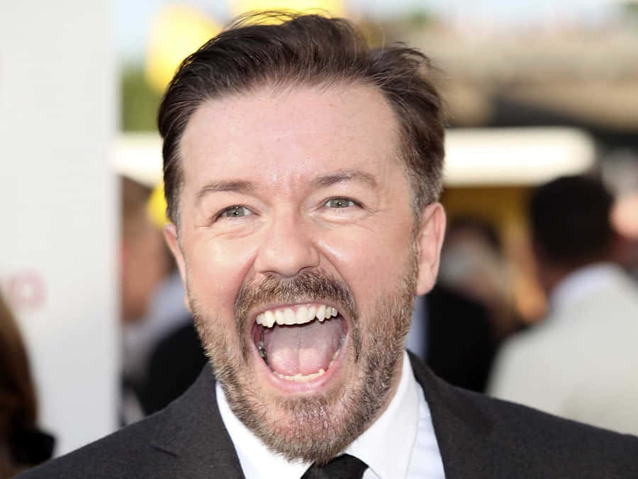 British Comedian And Actor Ricky Gervais Strikes A Pose Wallpaper