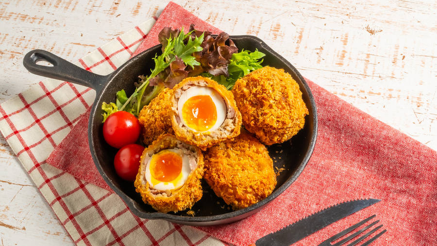 British Scotch Eggs Dish With Tomato And Herbs Wallpaper