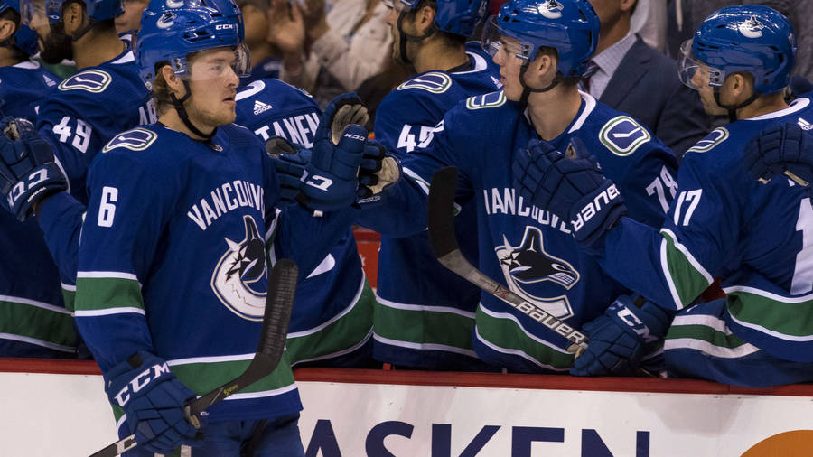 Brock Boeser Celebrate Goal Teammates Wallpaper