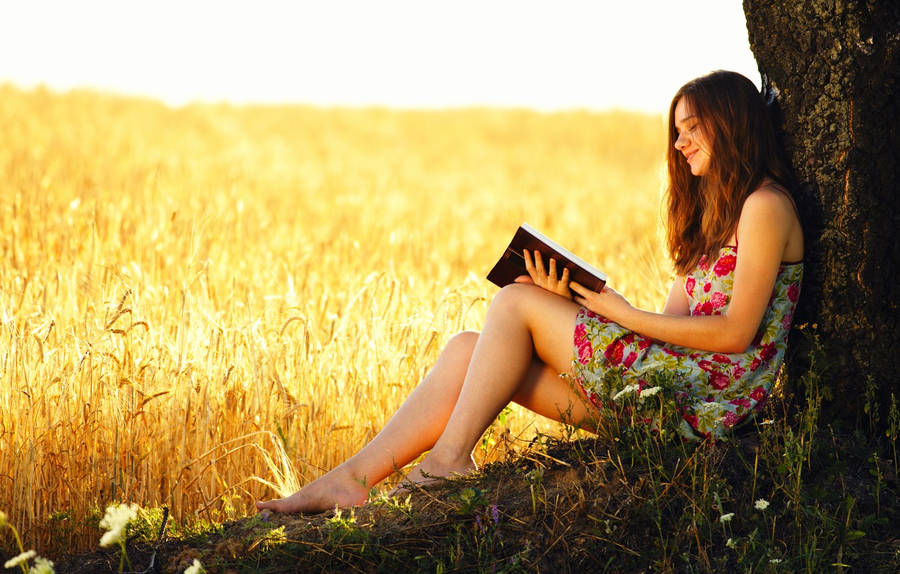 Brunette Woman Reading Under Tree Wallpaper