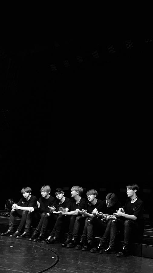 Bts Black Members Sitting Wallpaper