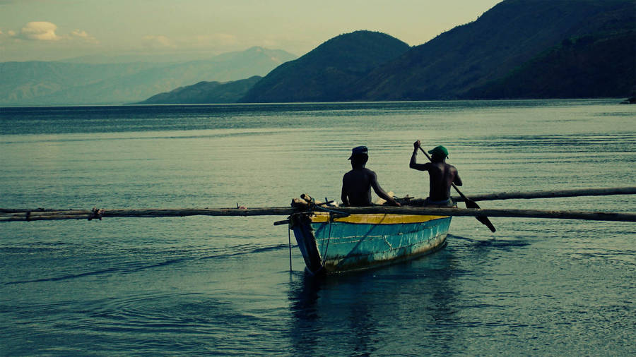 Burundi Fishermen Paddling A Traditional Canoe Wallpaper