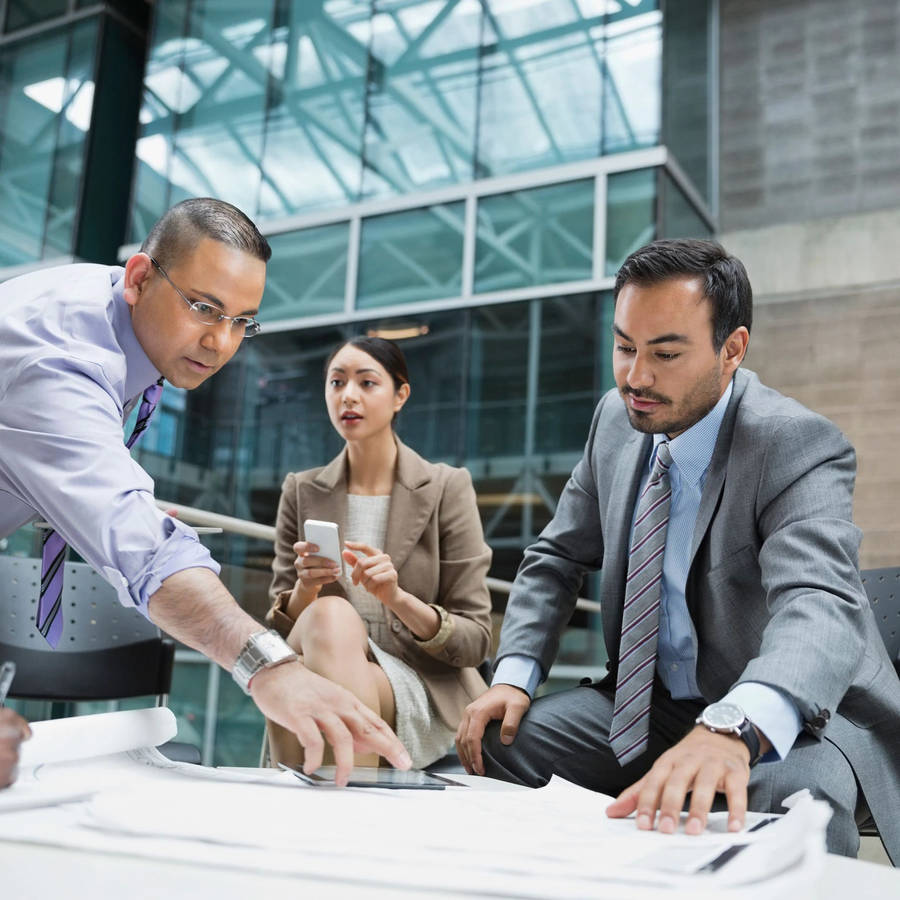 Business Partners In Discussion At Enterprise Meeting Wallpaper