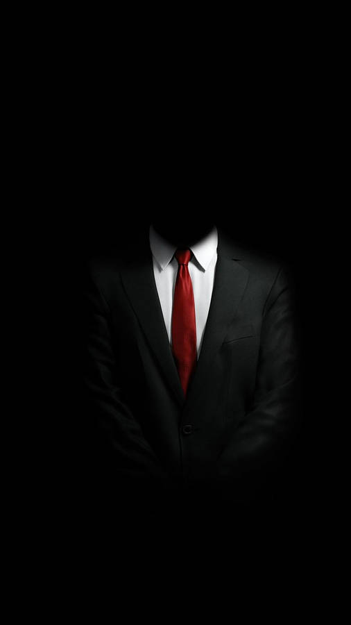 Businessman Using Mobile Phone In Dark Setting Wallpaper