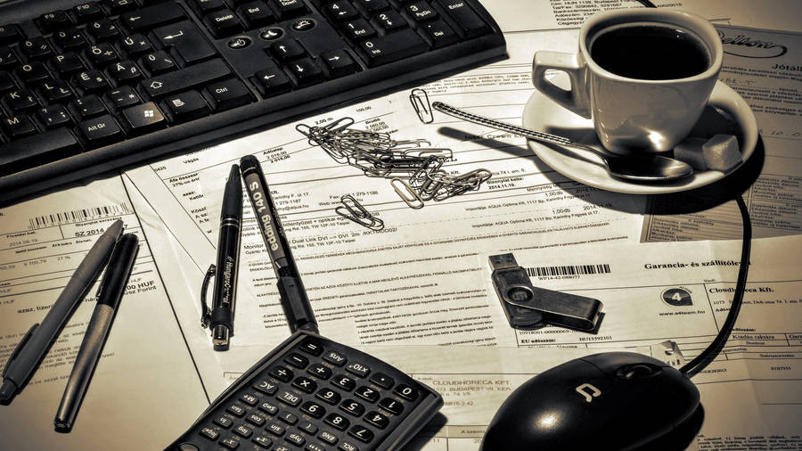 Calculator On Messy Office Table Wallpaper