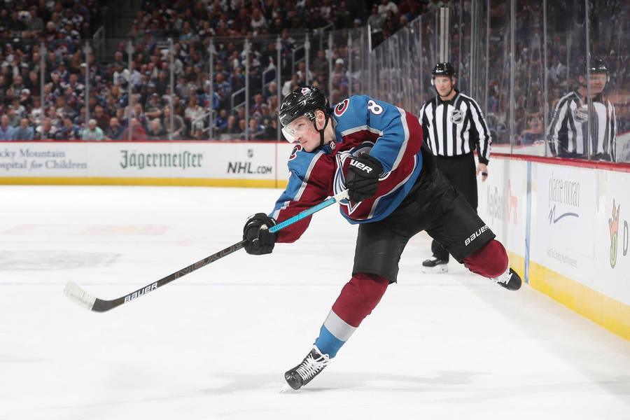 Cale Makar Deftly Passes The Puck In A Tense Game Moment. Wallpaper