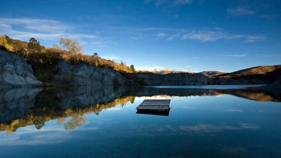 Calming Desktop Lake Surrounded By Mountain Wallpaper