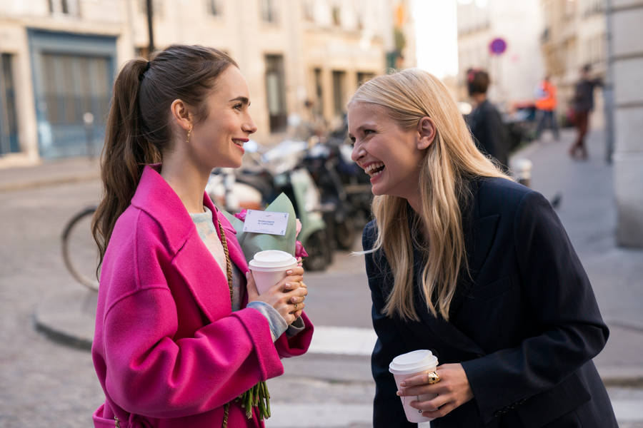 Camille And Emily In Paris Laughing Wallpaper