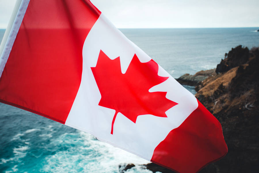 Canadian Flag Rocky Cliff Sea Wallpaper