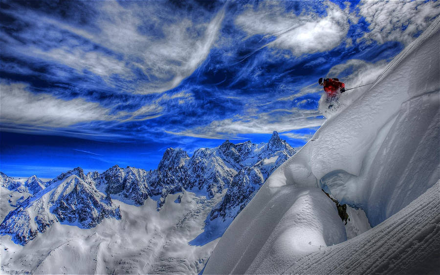 Caption: A Breathtaking View Of Snow Mountain Skiing Wallpaper