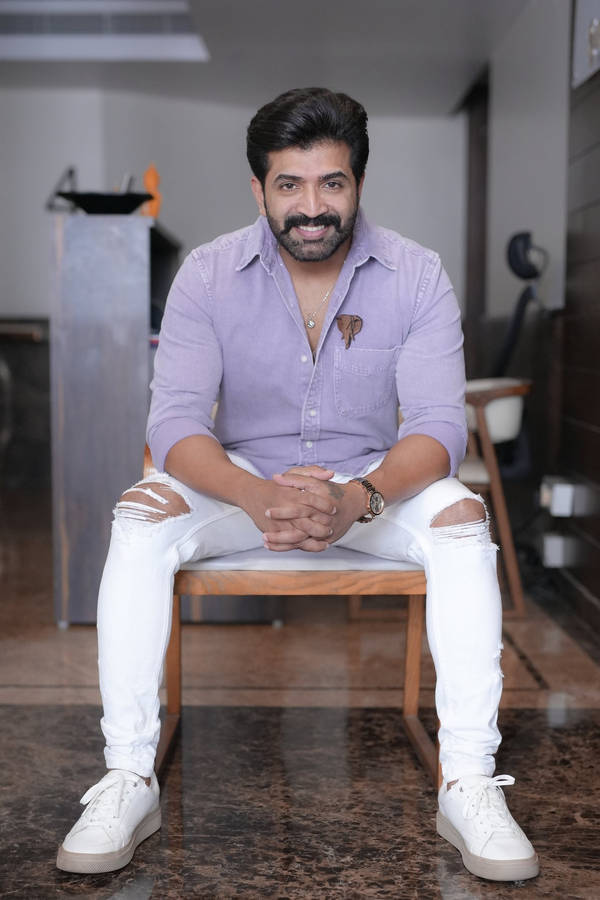 Caption: Arun Vijay Adorning A Serene Moment On A Chair Wallpaper