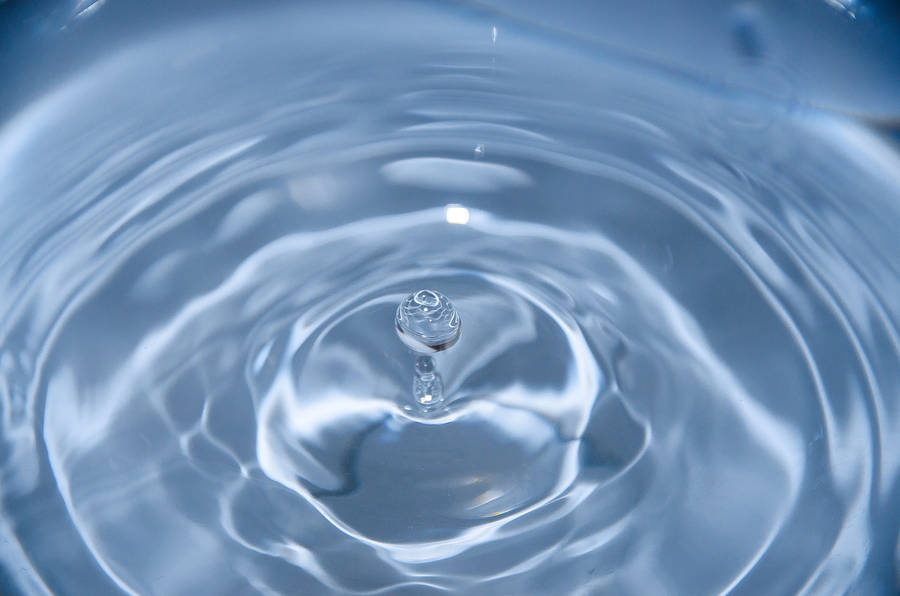 Caption: Calming Flow Of Water In Household Sink Wallpaper