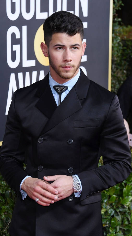 Caption: Charismatic Nick Jonas Slays In Chic Black Suit Wallpaper