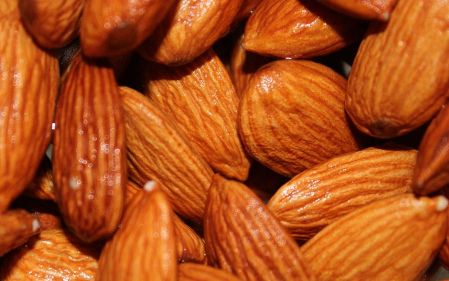 Caption: Close-up Shot Of Almond Nuts Wallpaper