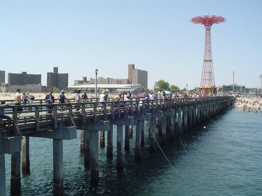 Caption: Coney Island's Iconic Parachute Pier Against A Sunset Sky Wallpaper