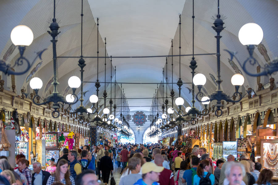 Caption: Dynamic Bustle At The Historic Cloth Hall, Krakow, Poland Wallpaper