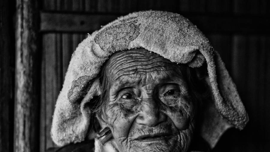 Caption: Elderly Woman Contemplating Life Wallpaper