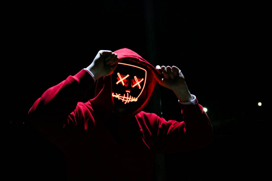 Caption: Enigmatic Figure In Dark Red Hoodie Wallpaper