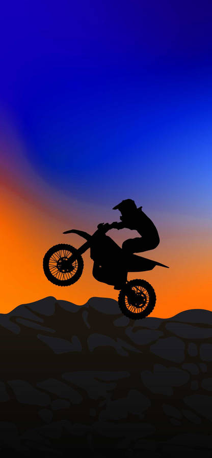 Caption: Extreme Thrill - Dirt Bike Silhouette Taking Flight At Sunset Wallpaper