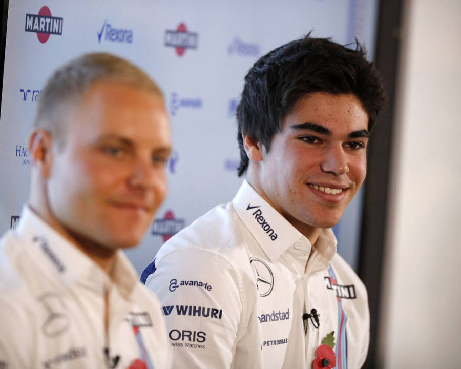 Caption: Fierce Competition: Lance Stroll And Valterri Bottas In Close Contest Wallpaper