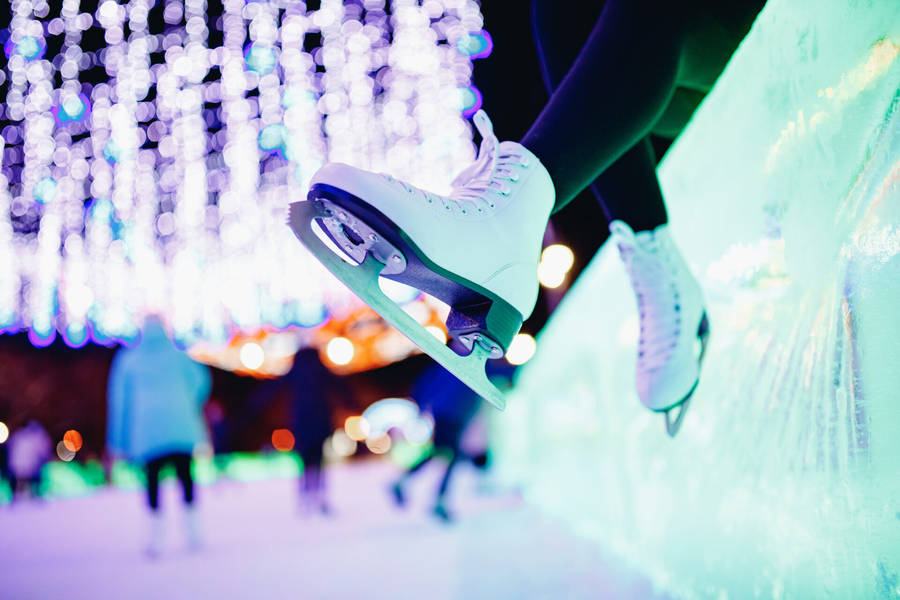 Caption: Grace On Ice: A Pair Of White Ice Skating Shoes Wallpaper