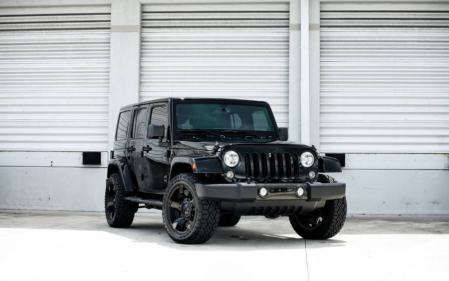 Caption: Impressive Black Jeep In Glossy Finish Wallpaper