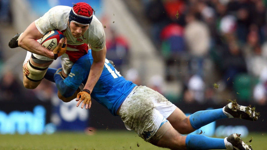 Caption: Intense Rugby Action - The England Rugby Tackle Wallpaper