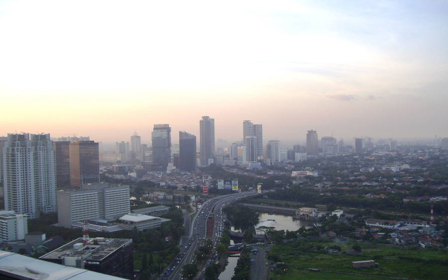 Caption: Jakarta's Majestic City Skyline At Dusk Wallpaper