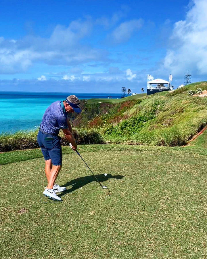 Caption: Luke Donald Contemplating His Next Stroke Against A Stunning Seaside View Wallpaper