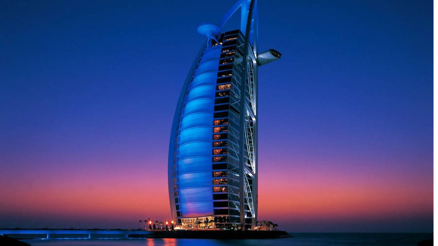 Caption: Majestic Burj Al Arab Against The Minimalist Dubai Skyline Wallpaper