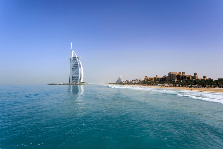 Caption: Majestic Burj Al Arab Under The Clear Sky Wallpaper