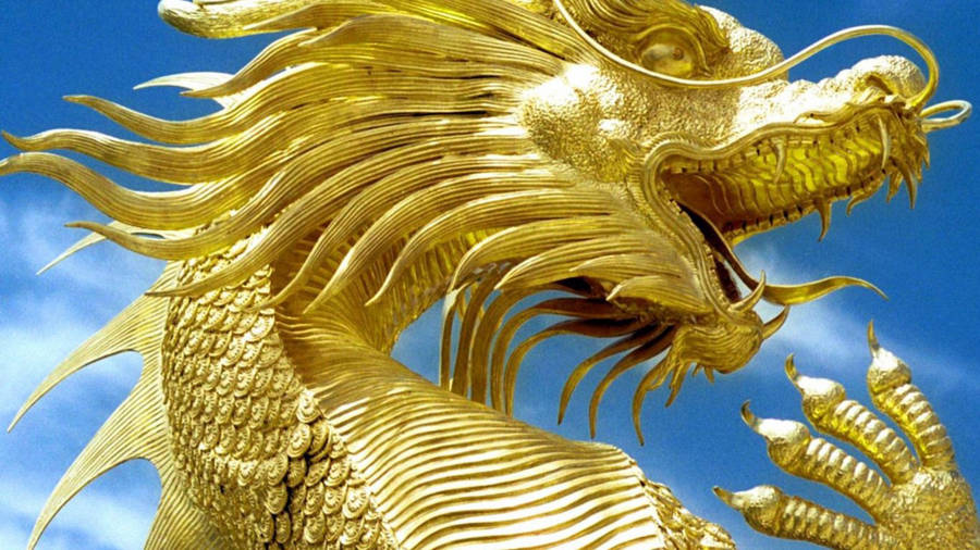 Caption: Majestic Golden Dragon Sculpture Wallpaper